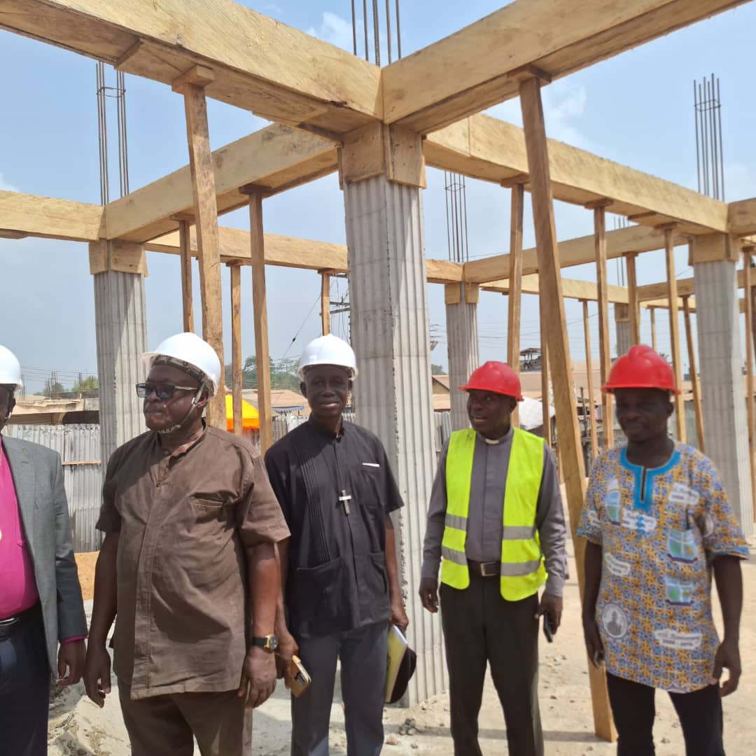 Group of people wearing hard hats at a construction site in Ghana
